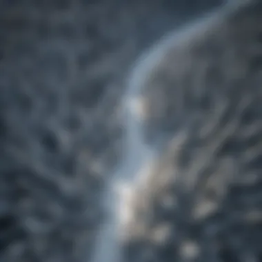 An aerial view of a snow-covered forest showcasing the impact of snowfall.