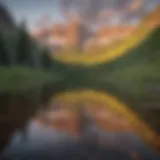 A panoramic view of the Maroon Bells reflecting in the serene waters of Maroon Lake during sunrise